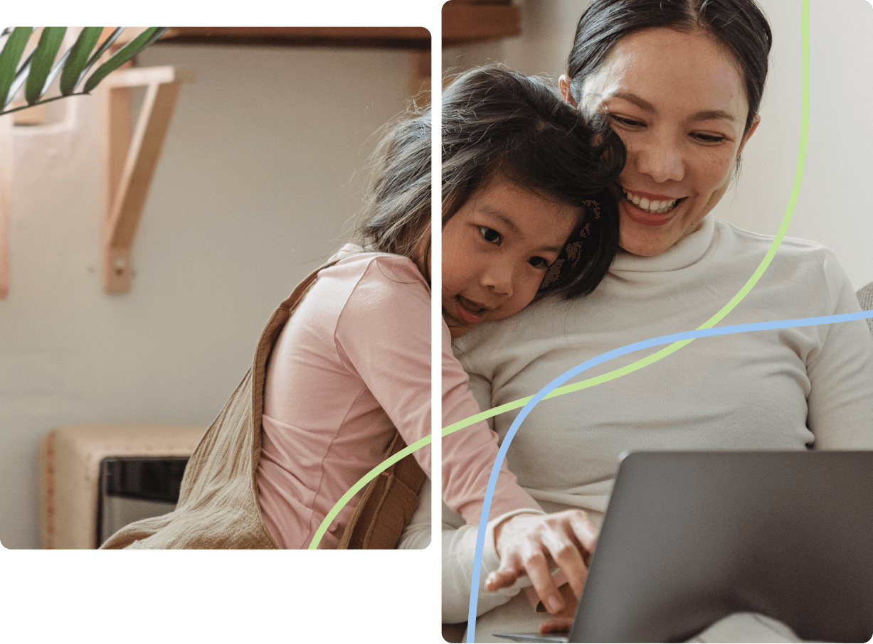 Daughter hugging mom, looking at a computer