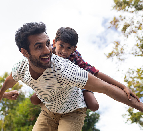 Father with his son on his back, arms out