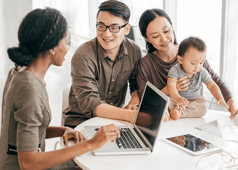 A family with a woman on the computer.