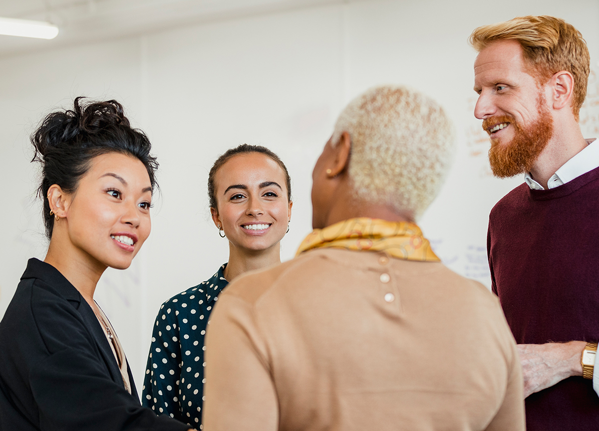 A group of employees talking in an office